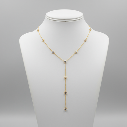 Gold necklace with small stones on a mannequin